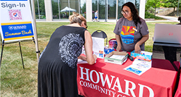 Student signs in at Howard Community College Summer Bash registration table.