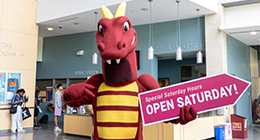 Duncan the Dragon mascot holding an 